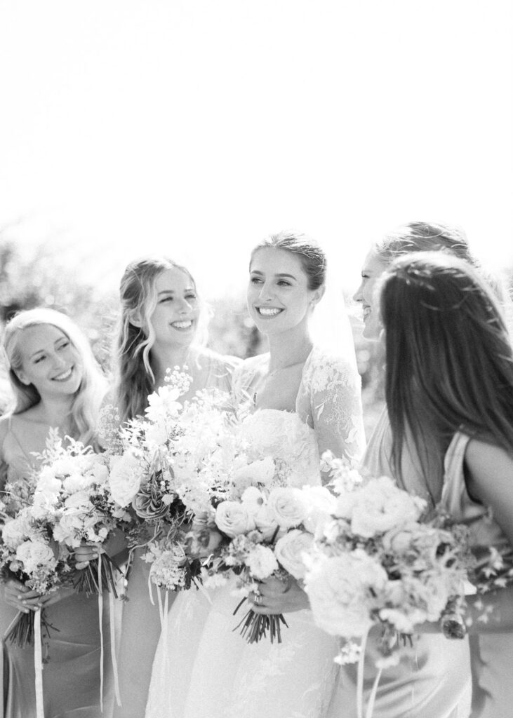 Cotswolds wedding in black and white of a bride and her bridemaids holding their bouquets